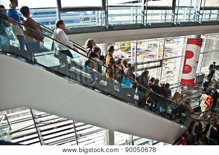 Visitors Inside The Fair Hall On Moving Staircase