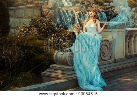 Young Girl Near A Waterfall In The Garden.