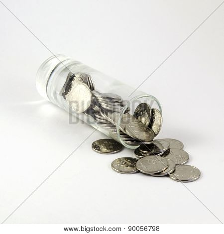 Many ruble coins in a shot glass