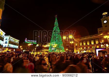 People Have Fun In Christmas Time Passing The Famous Illuminated Christmas Tree At Puerta Del Sol