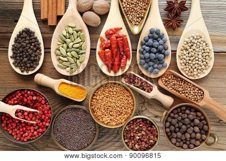 Spices and herbs in metal bowls and wooden spoons. Food and cuisine ingredients