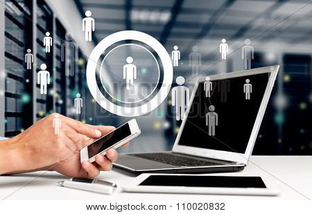 Male hands with phone on laptop  on office table