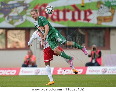 VIENNA, AUSTRIA - SEPTEMBER 28, 2014: Alan (#27 Salzburg) and Mario Sonnleitner (#6 Rapid) fight for the ball in an Austrian soccer league game.