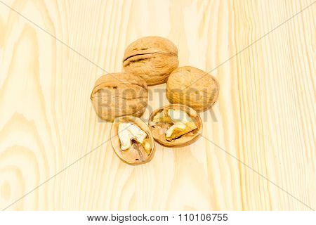 Several Walnuts On A Wooden Surface