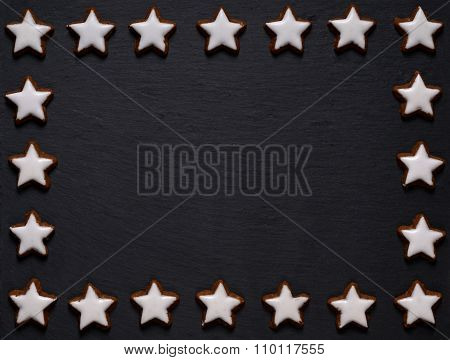 black slate board with star-shaped cookie frame