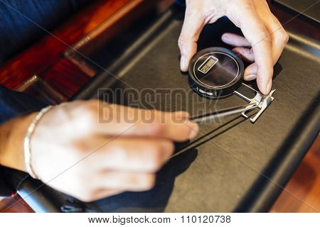 Jeweler Checking Size Of Diamond