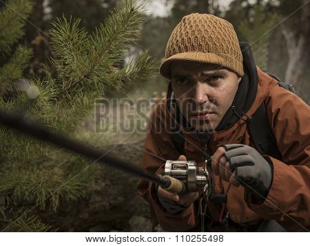Mature man fishing  on the wild river