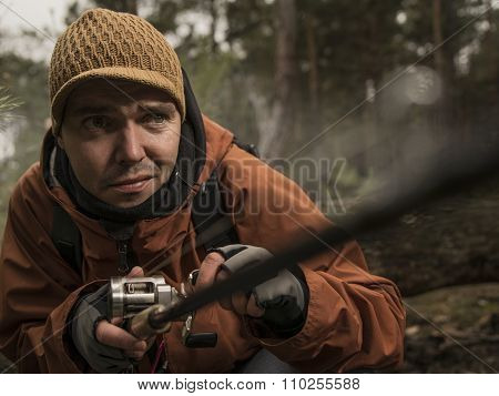 Mature man fishing  on the wild river