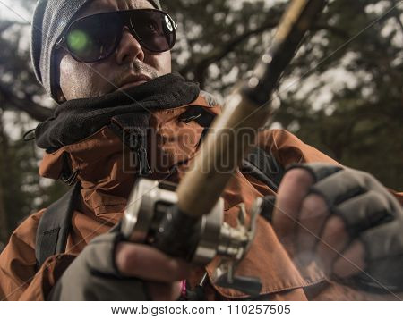 Mature man fishing  on the wild river