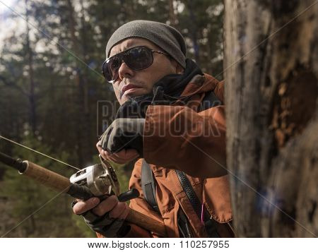 Mature man fishing  on the wild river