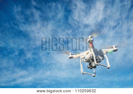 FORT COLLINS CO, USA, DECEMBER 2, 2015:  DJI Phantom 3 quadcopter  drone is flying with a 4K video camera against blue sky.