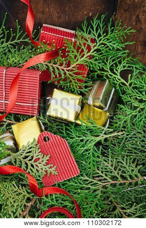 Branches Of Christmas Fir Tree  With Gifts And Red Ribbon