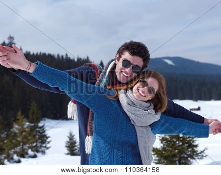 romantic winter  scene, happy young couple having fun on fresh show on winter vacatio, mountain nature landscape