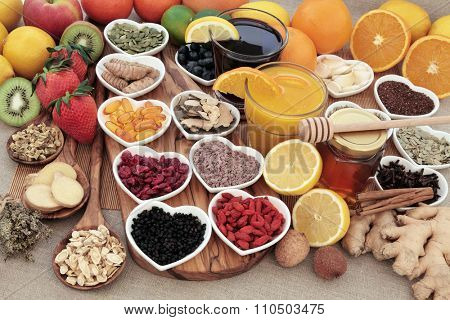 Healthy super food for cold remedy with fruit, orange and blackcurrant drinks, vitamin c supplement capsules, honey and medicinal herbs and spices, high in antioxidants.
