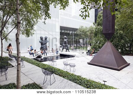 New York City, 12 September 2015: People Sit And Walk In Sculpture Garden Of Moma New York