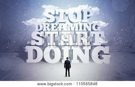A lazy sales person standing in emty space with huge block letters illustration saying stop dreaming start doing and clouds concept