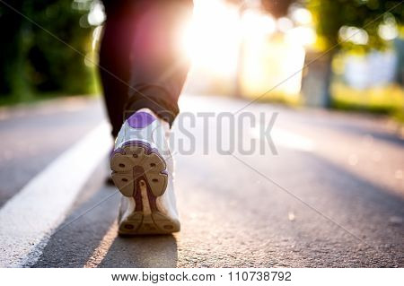 Close-up Of Athlete Shoes While Running In Park. Fitness Concept