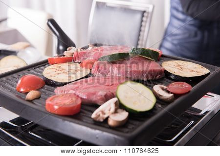 Steaks And Mushrooms On The Raclette  Cooking