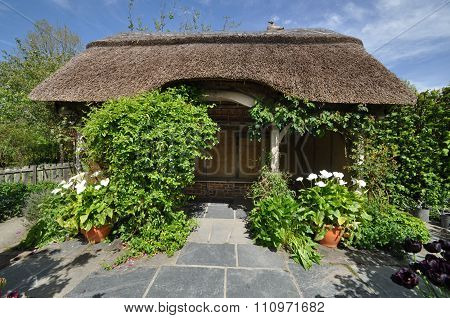 Thatched summerhouse in an English style garden. Taken near Torrington North Devon England