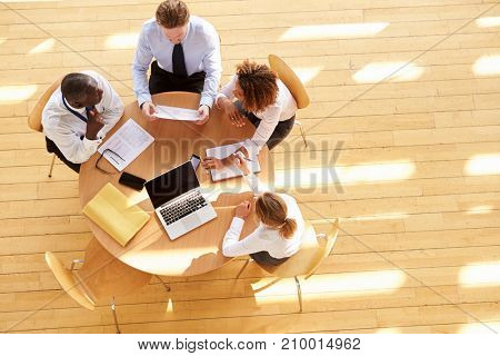 Four business colleagues in a team meeting, aerial view