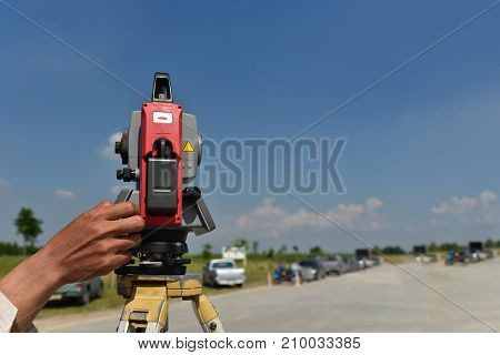 Modern surveyor equipment theodolite or tacheometer used in surveying and building construction for precise measurement. Total station outdoor at construction site. Copy space