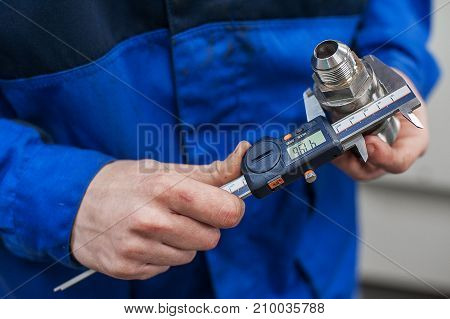 Engineer In Factory With Apprentice Checks Component Quality