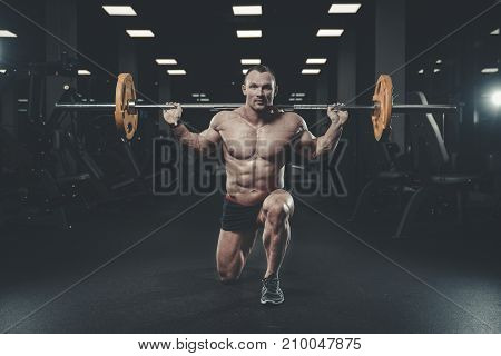 Handsome Model Young Man Training Legs In Gym