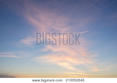 Evening sunlight on coast pink clouds blue sky reflection on water. Beach in summer. Seaside natural environment. Shore in Kesselaid small island in Estonia. Nature Reserve in North Europe