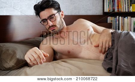 Young Handsome Shirtless Sleepy Man, Lying in Bed as He's Waking Up