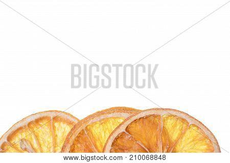 Three slices of dried orange on white background