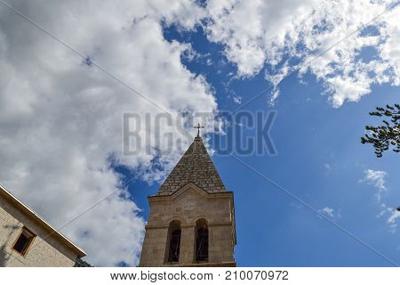 The top of the bell tower against the sky. Orthodox Church. Montenegro