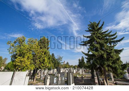 BELGRADE SERBIA - OCTOBER 2 2017: Graves and tombs in the Orthodox cemetry of Zemun northeast of Belgrade. Gardos tower can be seen in background