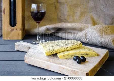Homemade Haloumi Cheese On Wooden Board With Olives