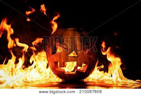 The Concept Of Halloween. The Evil Terrible Pumpkin Is Burning In The Hellish Tongues Of Flame. Jack