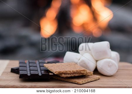 Smores Ingredients at a Beach Bonfire with Chocolate, Marshmellow, and Graham Crackers with Room for Copy