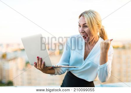 Beautiful Smart Business Lady Stand On The Roof With Laptop In Hands