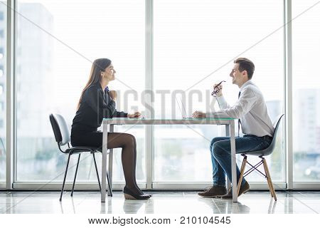 Businessman And Businesswoman Meeting In Modern Office Face To Face Discuss Plans