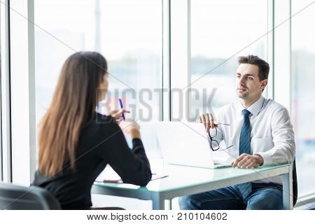 Business People Man And Woman Having Meeting At Table In Modern Office Against Panoramic Windows