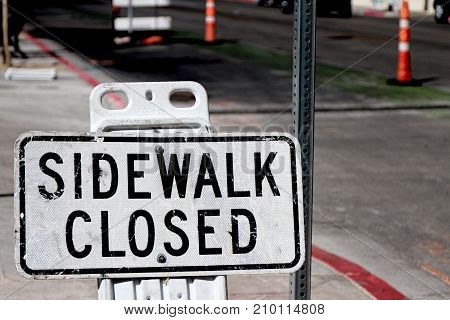 Sidewalk closed sign board closing a sidewalk