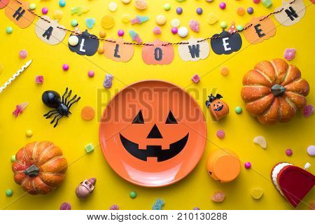 halloween dish with spoone and  decoration with colorful candy