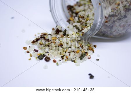 Spilled coarce sea salt with different spices