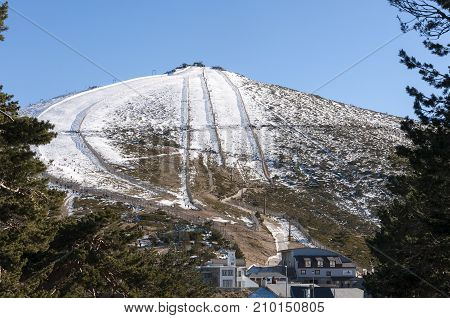 Views of Navacerrada Ski Resort from behind the forest. Photo taken in Navacerrada Mountain Pass Madrid Spain on January 2015