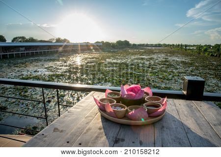 Lotus marsh and wood boat with sky background at Banglane Nakorn pathum Thailand.