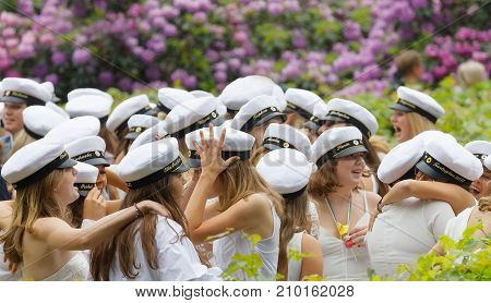 STOCKHOLM SWEDEN - JUN 13 2017: Happy teenagers wearing graduation caps hugging each other after graduation at the dance school BalettakademienJune 13 2017StockholmSweden