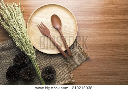 food wooden dinner dish and spoon, fork and decor top view
