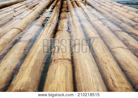 sturdy bamboo wood, a raft made of bamboo, background,bamboo floating on the water over the dam.