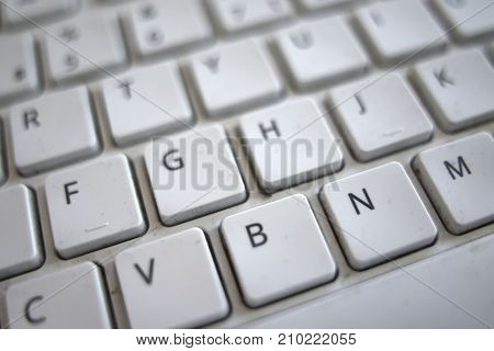 Keyboard buttons, computer key pad with letters. High conrast black and white with fall off focus