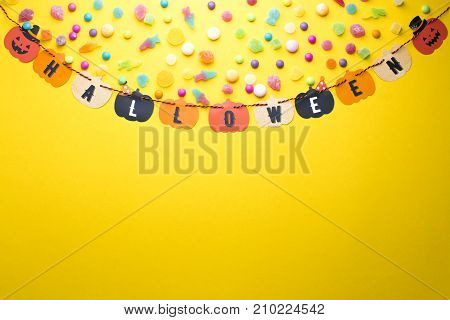 top view of halloween paper hanging with candy