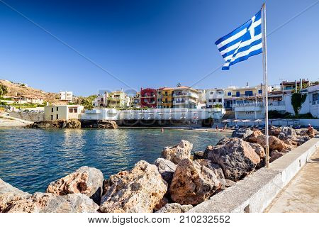PANORMOS CRETE - SEPTEMBER 16: Waving greek flag in resort Panormos on September 16 2017in Panormos
