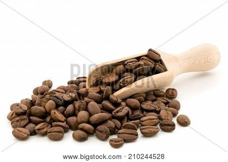 Coffee beans with a wooden shovel on white background, isolated.